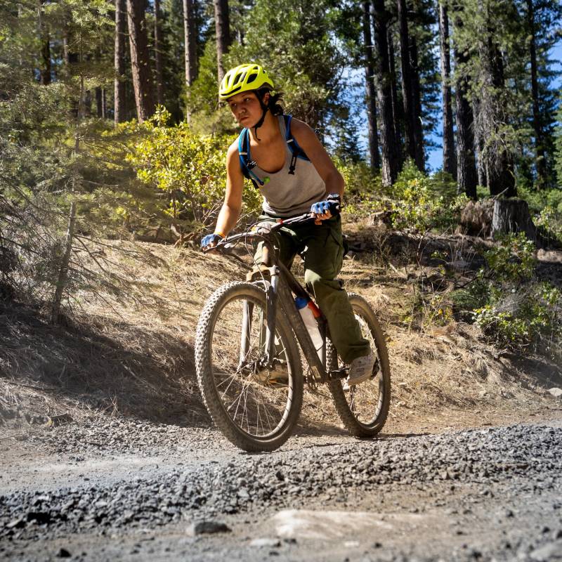 Scout mountain biking on a trail at Camp Hi-Sierra